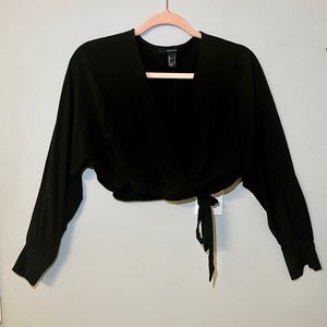 Black long sleeve blouse, cropped and has a V cut.